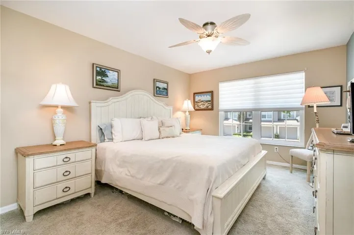 2nd Bedroom with light carpet, baseboards, and a ceiling fan