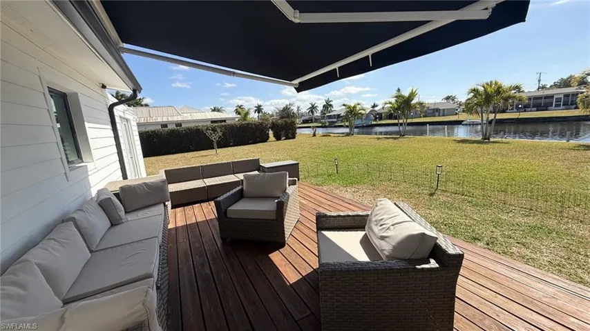 Wooden deck with an outdoor lounge area, a lawn, a residential view, and a water view