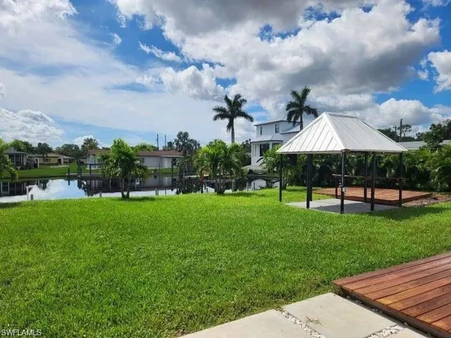Surrounding community with a gazebo, a patio area, and a water view