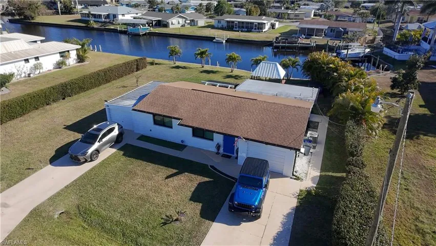 Aerial perspective of suburban area with a nearby body of water