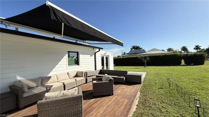 Wooden deck featuring an outdoor living space and a lawn