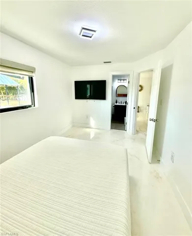 Unfurnished bedroom featuring a textured ceiling and concrete flooring