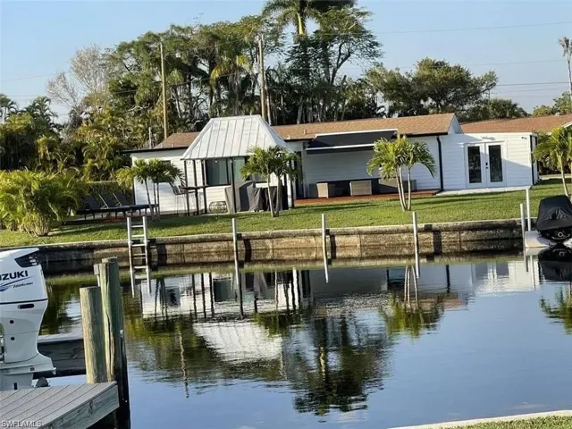 Dock with a water view and a yard