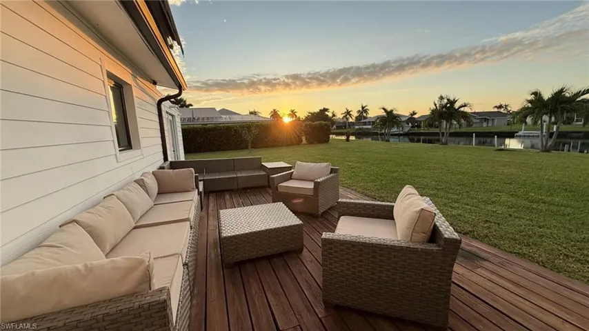 Wooden deck with a lawn and an outdoor living space