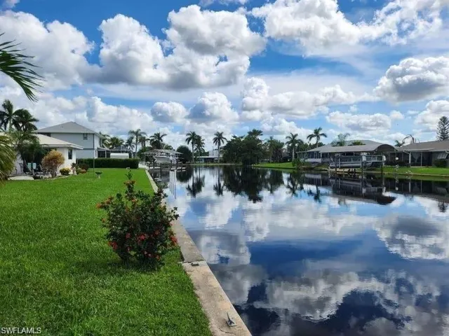 Water view with a dock and nearby suburban area