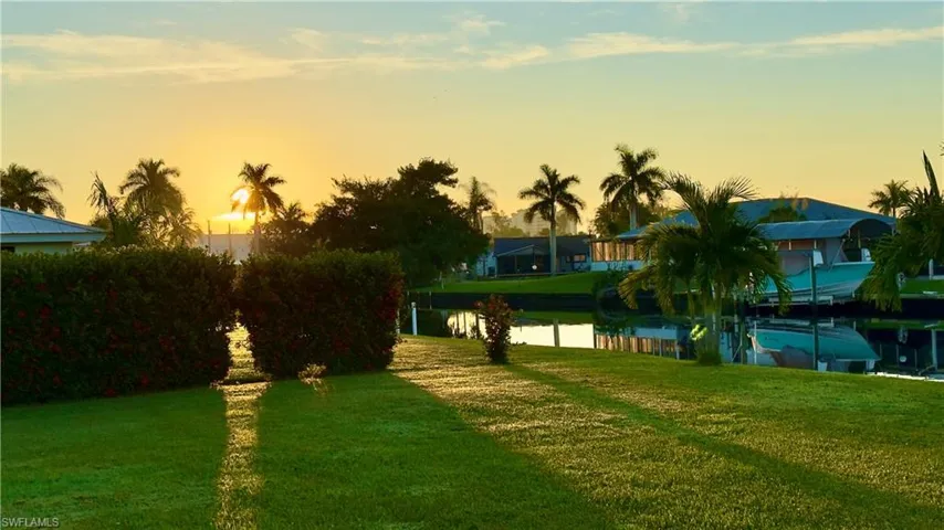 Yard at dusk featuring a lawn