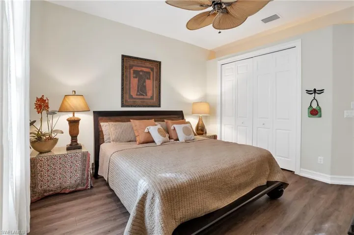 Bedroom featuring wood finished floors, a closet, and a ceiling fan