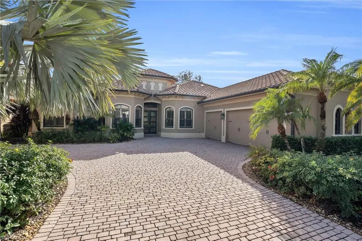 Mediterranean / spanish house featuring stucco siding, an attached garage, decorative driveway, and a tile roof