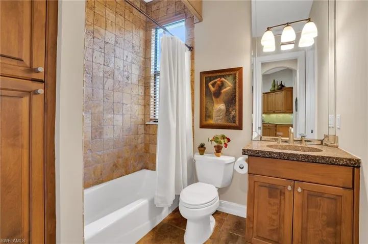 Full bathroom featuring vanity and shower / bath combination with curtain