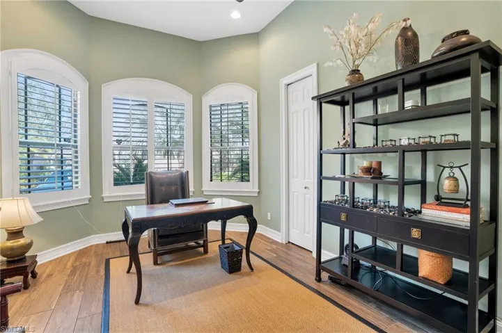 Home office featuring wood finished floors and baseboards