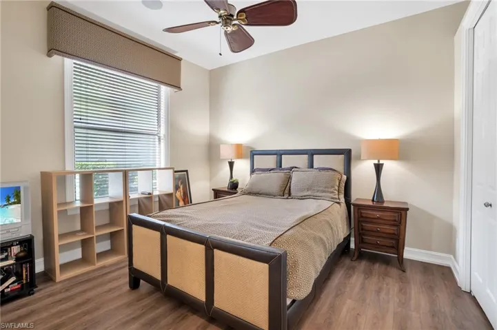 Bedroom with a closet, wood finished floors, and a ceiling fan