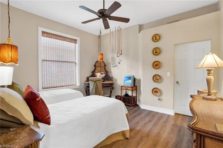 Bedroom featuring wood finished floors and a ceiling fan