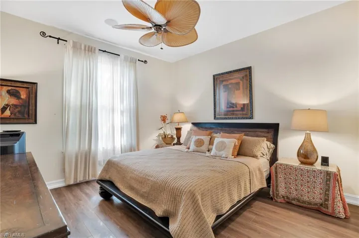 Bedroom with wood finished floors and a ceiling fan