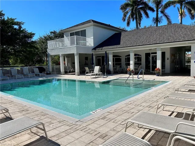 Pool with a patio and fence