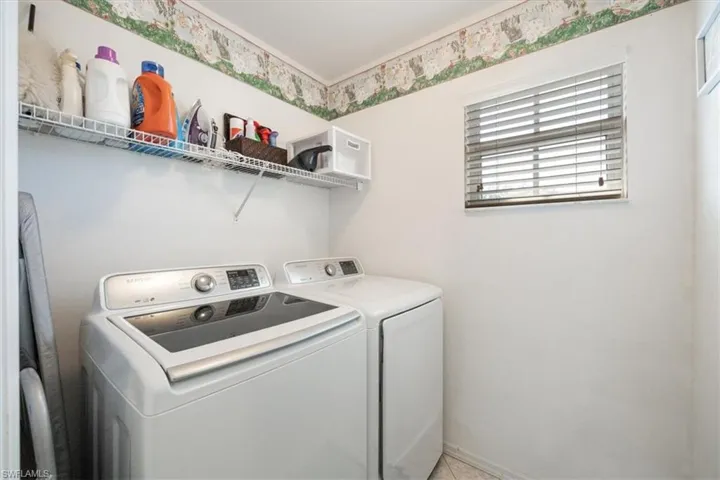 Laundry area with washer and dryer, laundry area, and baseboards
