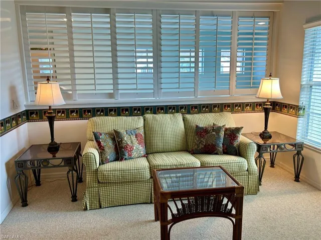 Living area with carpet floors and baseboards