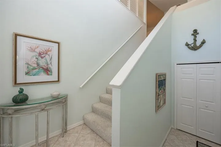 Stairs featuring baseboards and tile patterned flooring