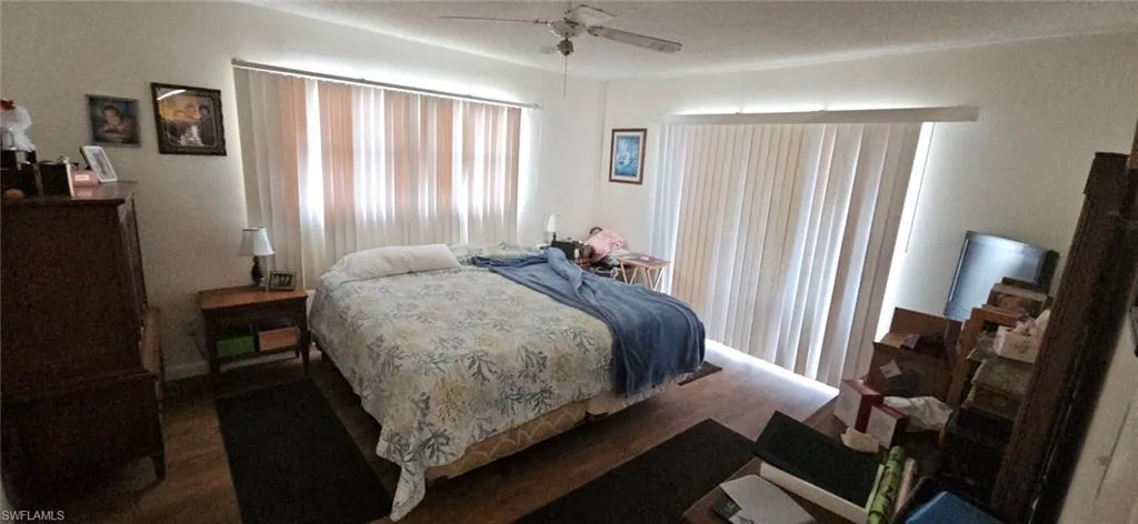 Bedroom featuring ceiling fan and dark hardwood / wood-style flooring