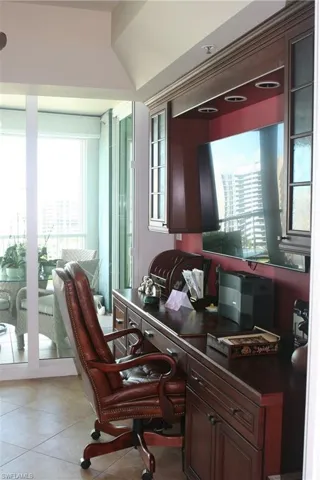 Office space and TV room with sliding doors to balcony