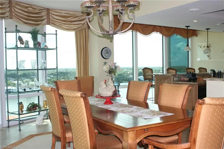 Dining space , view of city, a chandelier, and light tile patterned floors