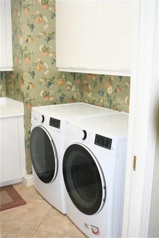 Large walk in laundry room with utility sink and lots of stoarge