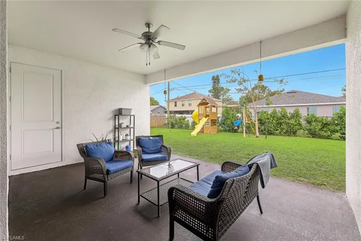 View of patio / terrace with a fenced backyard, ceiling fan, a playground, and outdoor lounge area