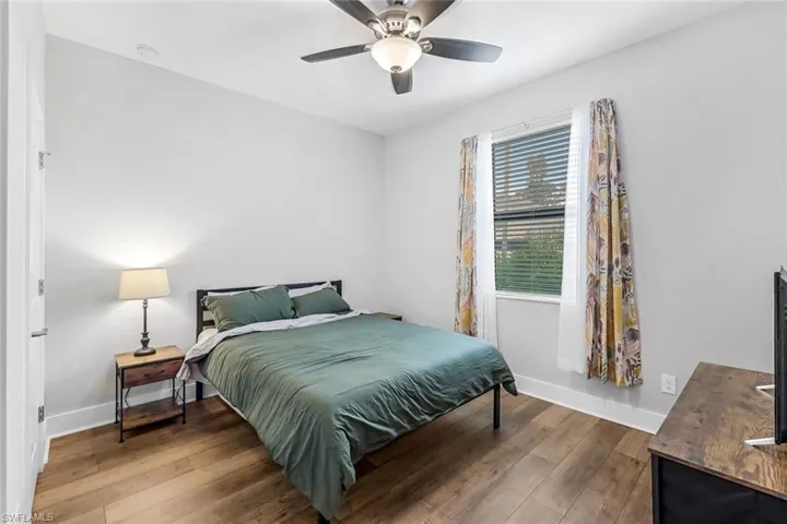 #2 Bedroom with baseboards, wood-type flooring, and a ceiling fan