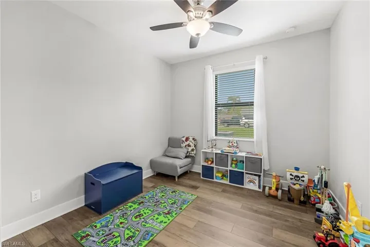#4 Bedroom/Play room featuring baseboards, a ceiling fan, and wood finished floors