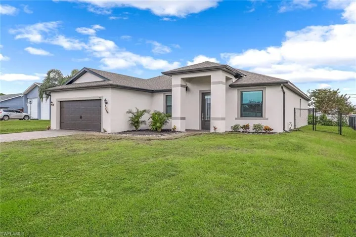 Prairie-style home featuring fence, concrete driveway, stucco siding, and an attached garage