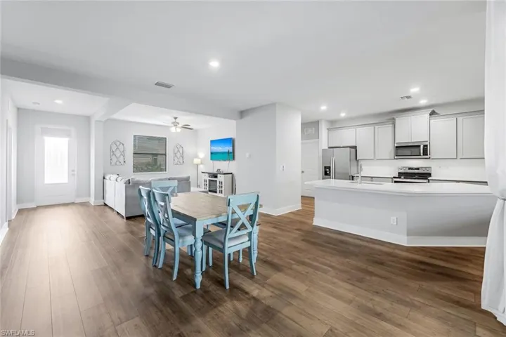 Dining area with recessed lighting, baseboards, visible vents, and dark wood-style floors