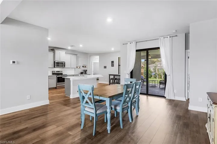 Dining area with recessed lighting, baseboards, and dark wood-style floors