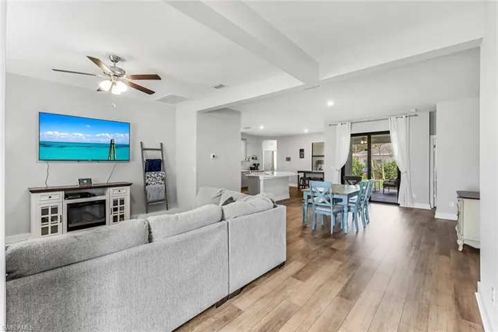 Living room featuring visible vents, a ceiling fan, wood finished floors, and recessed lighting