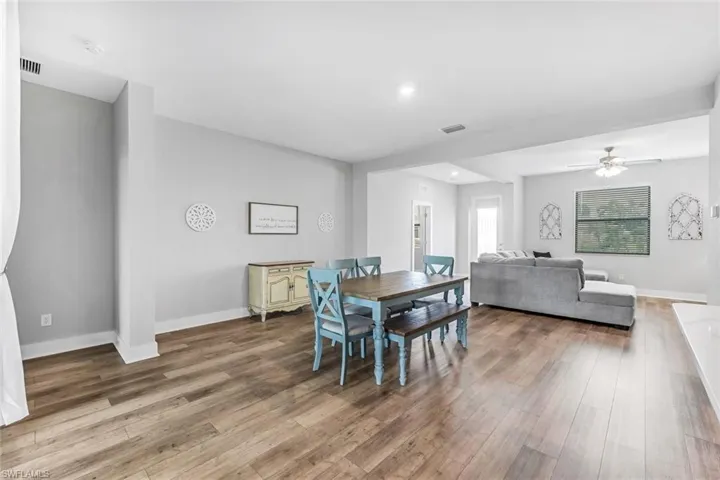 Dining area with baseboards, wood finished floors, and visible vents
