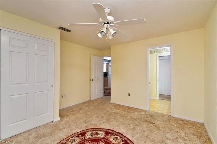 Unfurnished bedroom featuring light tile patterned flooring, a closet, and ceiling fan