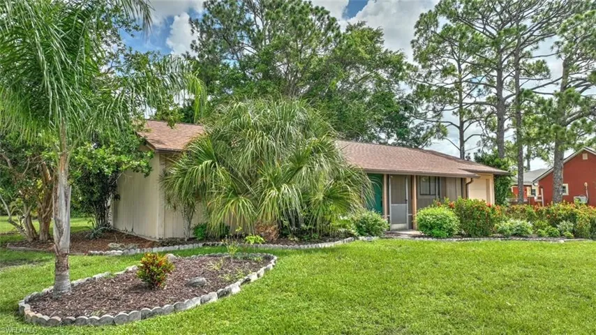 Ranch-style home featuring a front lawn