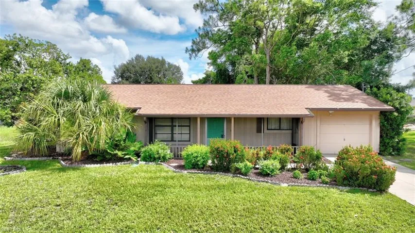 Ranch-style home with a garage and a front yard