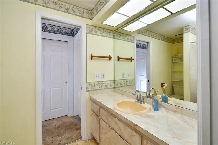 Bathroom with vanity, tile patterned floors, and toilet
