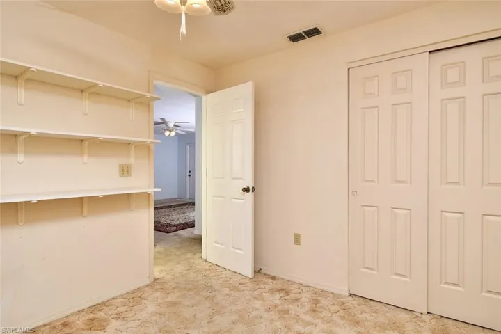 Unfurnished bedroom with light carpet and a closet