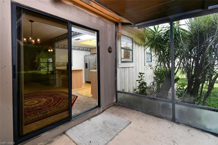 Doorway to property featuring a patio area