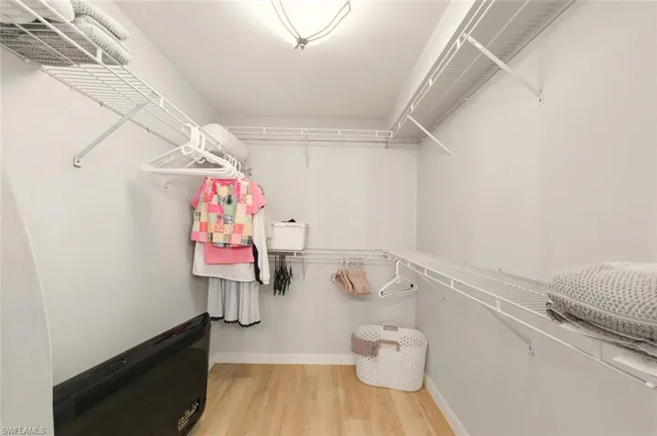 Spacious closet featuring light wood-type flooring