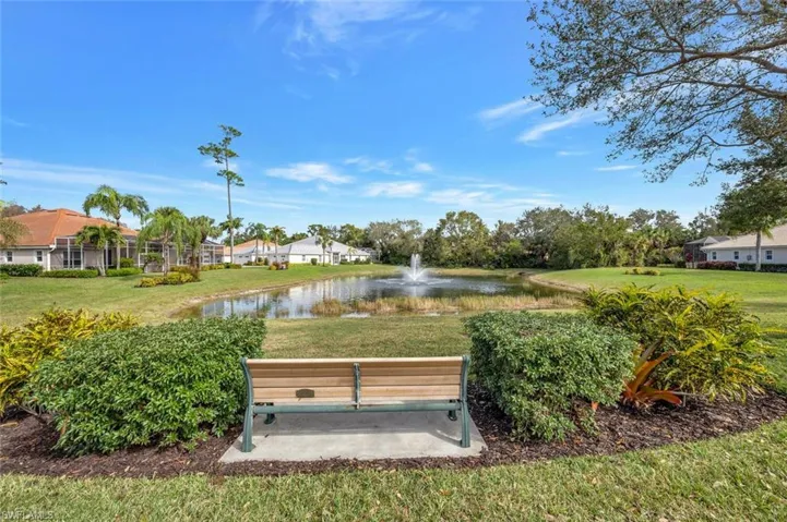 View of home's community featuring a lawn and a water view