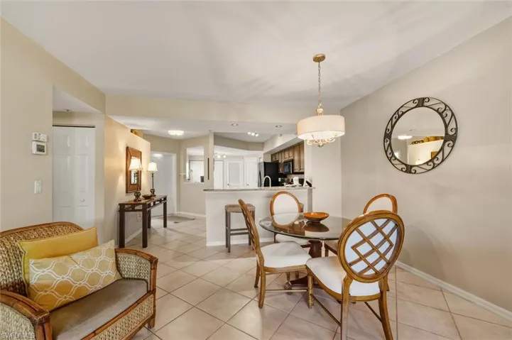 Dining space featuring light tile patterned floors, recessed lighting, and a chandelier