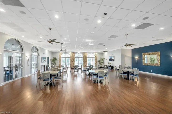 Dining room with ceiling fan, a drop ceiling, dark wood-type flooring, and recessed lighting