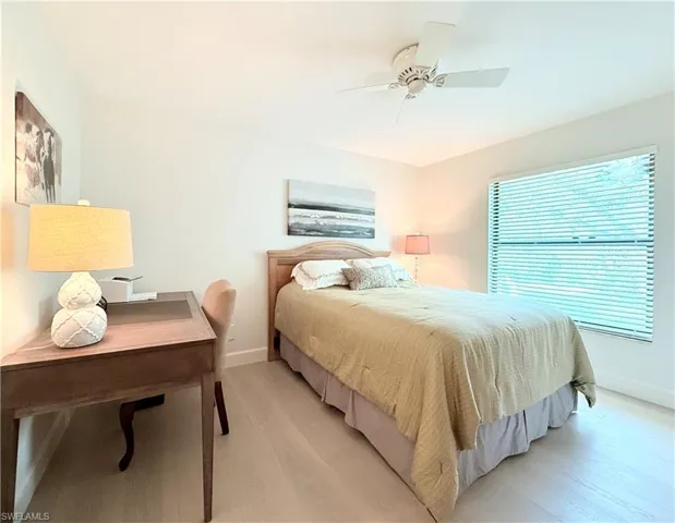 Guest bedroom has new luxury vinyl plank floor, side window and walk in closet