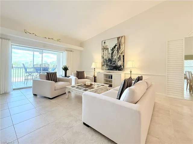 Neutral large tile flooring throughout entry, hallway, kitchen, dining room, living room and bath rooms
