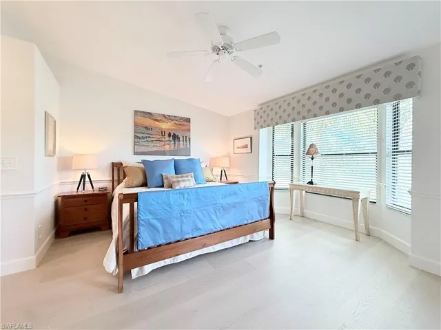 Primary bedroom has luxury vinyl floor and bay window that looks out to water and golf