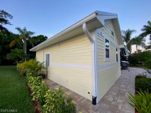 View of property exterior featuring a yard and a patio area
