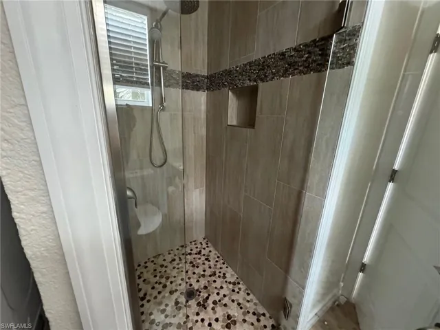 Bathroom with a shower with door