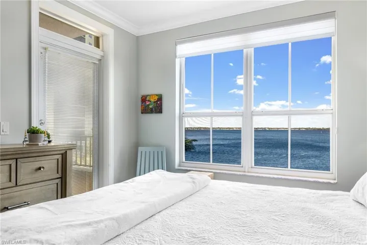 Bedroom featuring a water view and ornamental molding