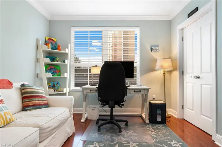 Office area featuring dark hardwood / wood-style flooring and ornamental molding